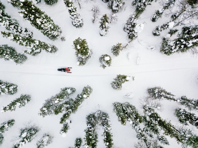 Aerial view of snowmobile in snow winter day in rural Finland, Lapland