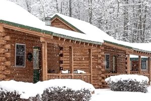 Snowy log cabin rentals at the New England Inn & Lodge, located in Intervale, NH.